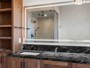 Full bathroom featuring a shower stall and vanity