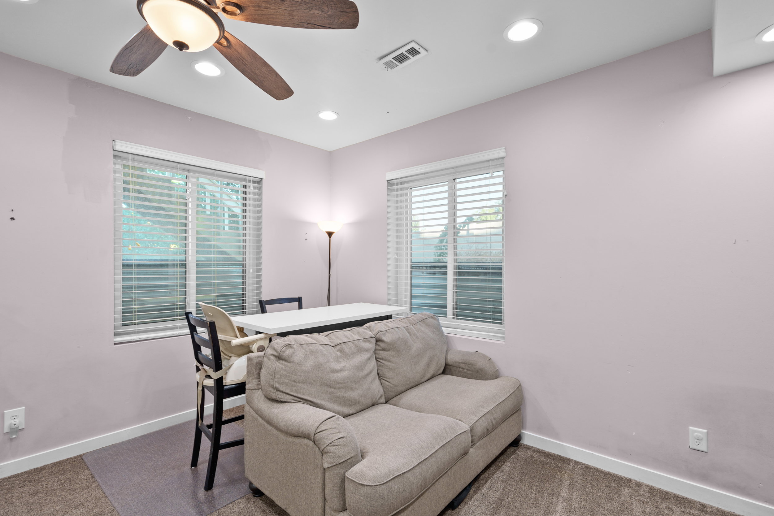 Carpeted living room featuring recessed lighting and a ceiling fan