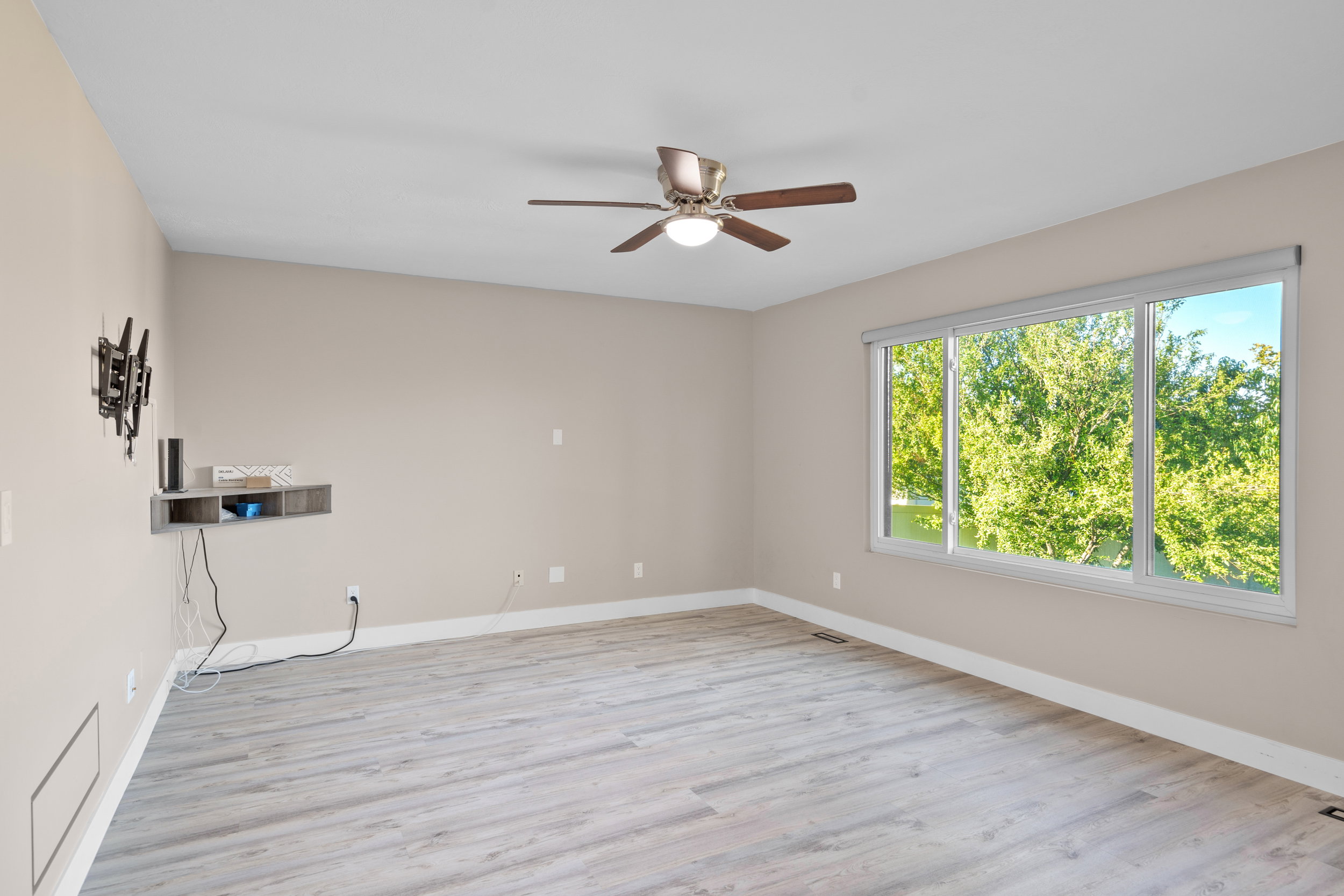 Unfurnished room with light wood-style floors and ceiling fan