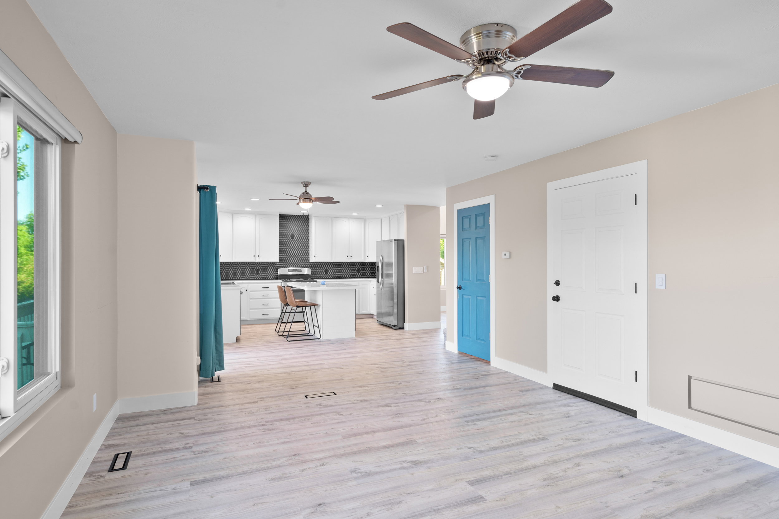 Unfurnished living room featuring ceiling fan, light wood-type flooring, healthy amount of natural light, and recessed lighting