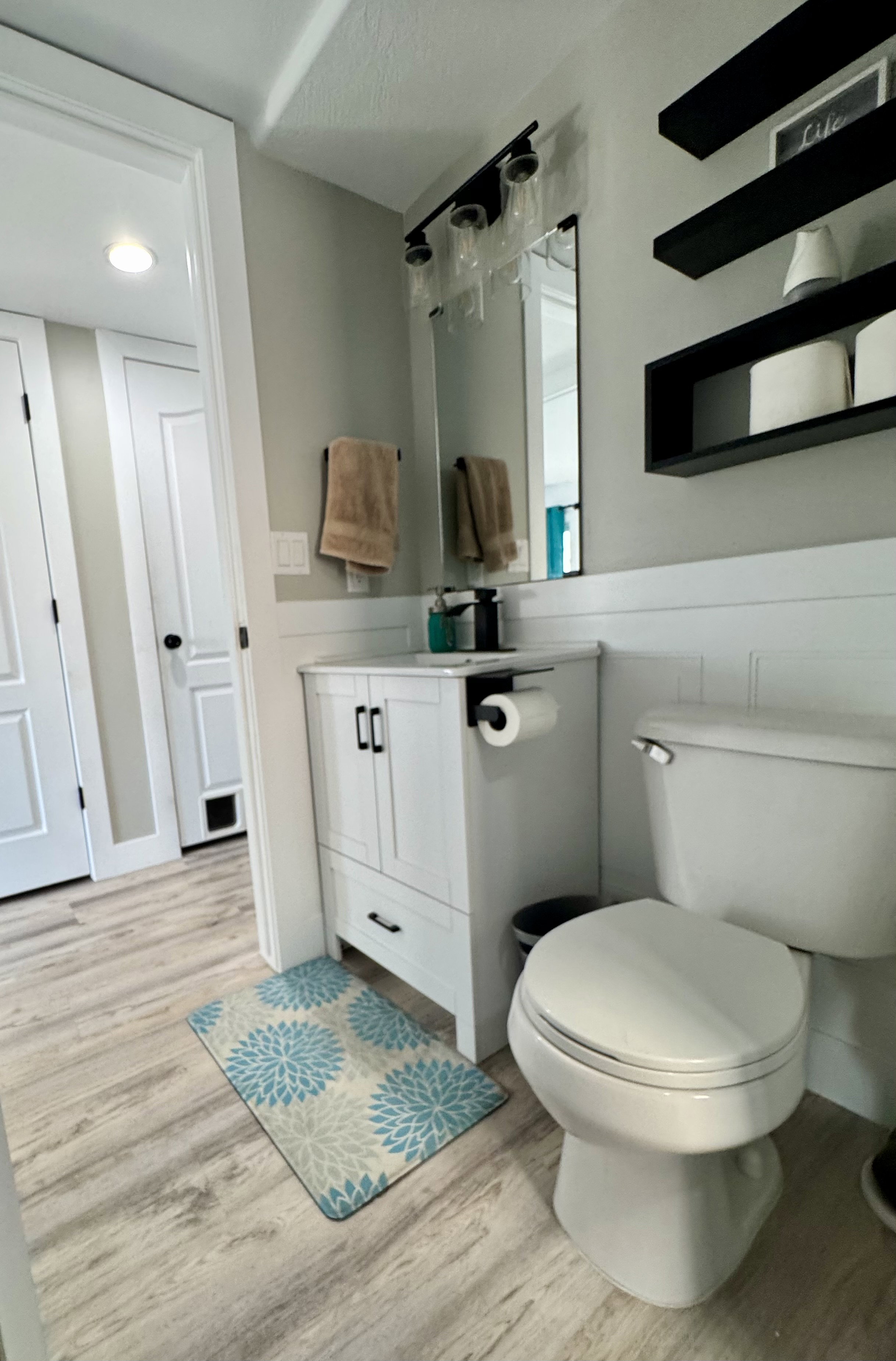 Bathroom with light wood-style flooring and vanity