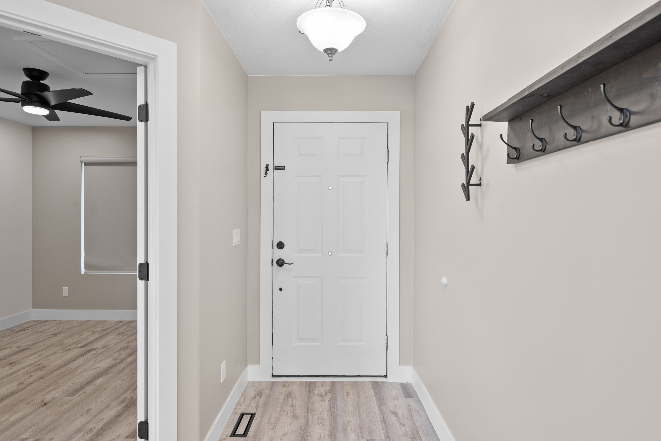 Doorway featuring wood finished floors and ceiling fan