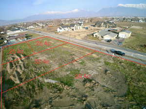 Aerial overview of property's location with property parcel outlined and mountains
