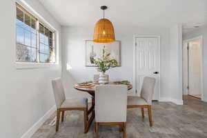 Dining area with light wood-style floors and baseboards