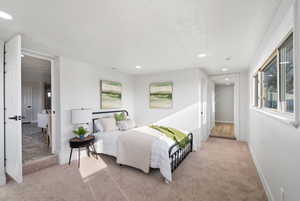 Bedroom featuring light carpet and recessed lighting