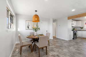 Dining space with baseboards and light wood-style floors