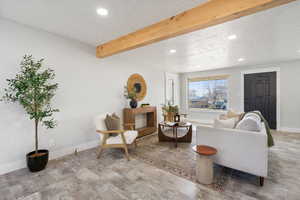 Living room with recessed lighting, a textured ceiling, and beam ceiling
