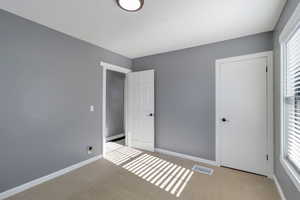 Unfurnished bedroom featuring baseboards and carpet flooring