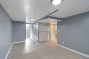 Empty room featuring wood finished floors and carpet