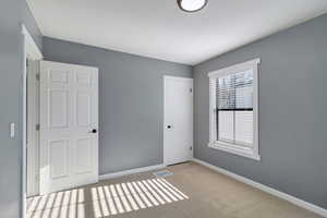 Unfurnished bedroom featuring carpet floors and a closet
