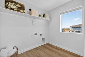 Laundry room with light wood-style floors, electric dryer hookup, and hookup for a washing machine