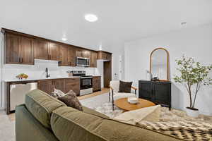Living area with light wood-style floors and recessed lighting