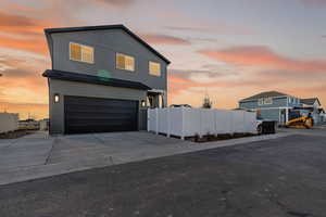 View of front of home featuring an attached garage and concrete driveway