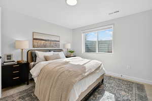 Bedroom featuring carpet floors and baseboards