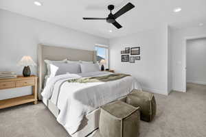 Bedroom featuring light colored carpet, a ceiling fan, and recessed lighting