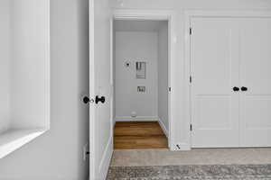 Washroom featuring hookup for a washing machine and light colored carpet