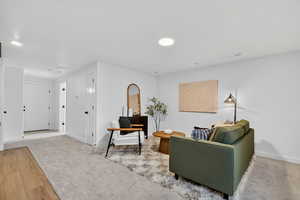 Living area featuring baseboards and wood finished floors