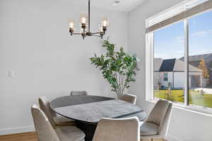 Dining space with a chandelier and light wood-style flooring