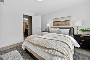 Carpeted bedroom featuring baseboards