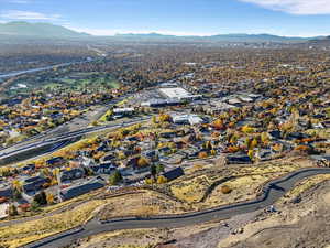 Aerial overview of property's location featuring a mountainous background and nearby suburban area
