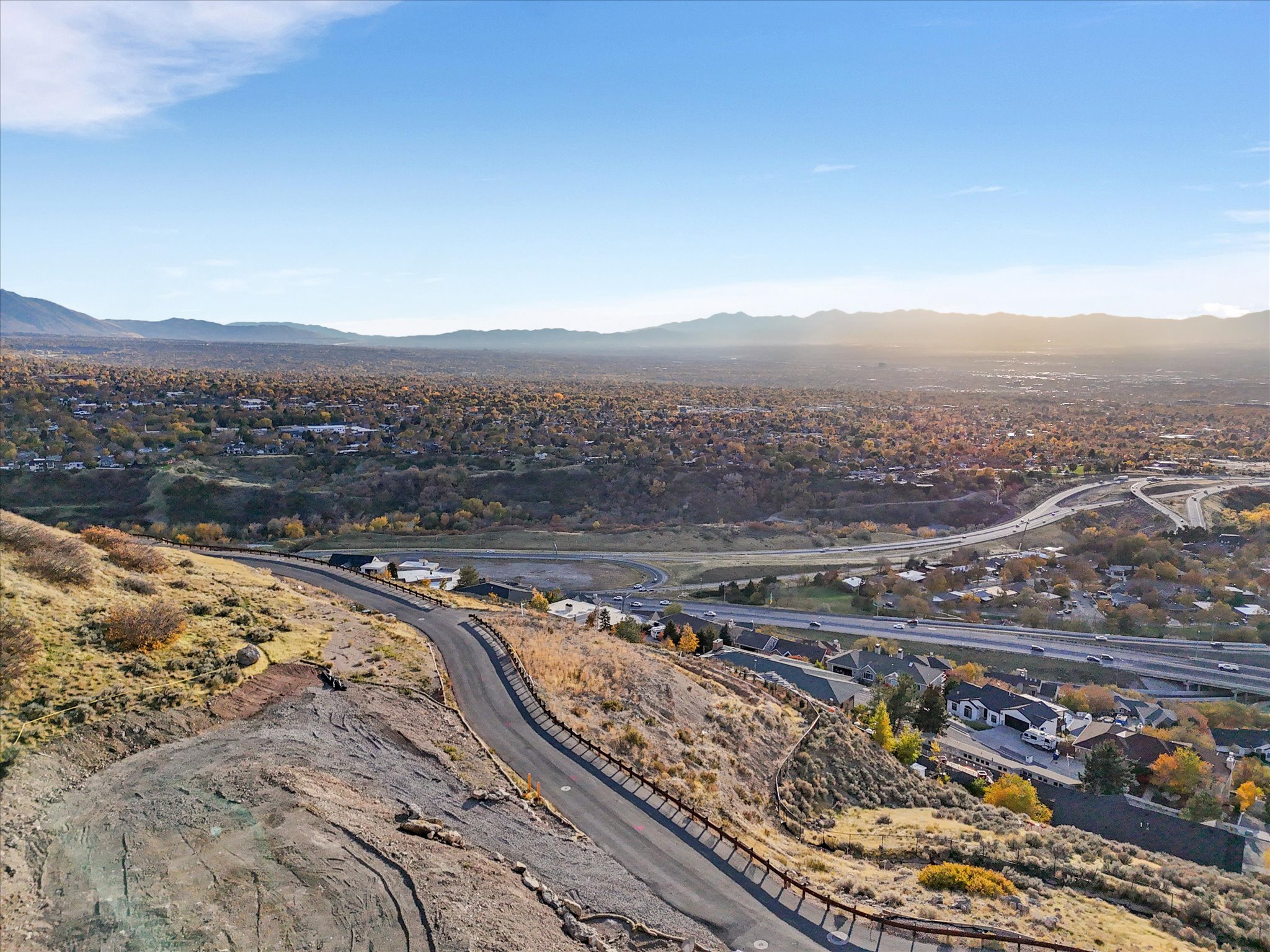 Aerial view of property and surrounding area featuring mountains