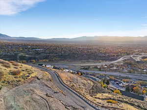 Aerial view of property and surrounding area featuring mountains