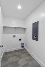 Laundry room featuring electric panel and hookup for a washing machine