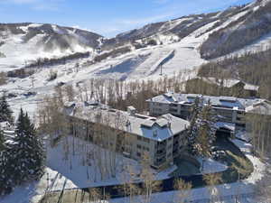 Snowy aerial view featuring a mountain view