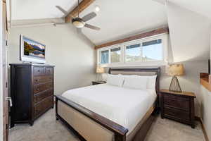 Bedroom with a ceiling fan and light carpet