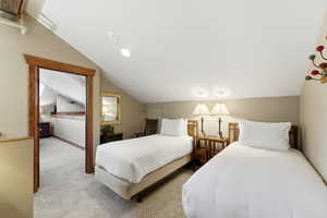 Bedroom featuring carpet, vaulted ceiling, and recessed lighting