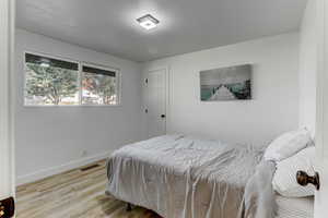 Bedroom featuring light wood finished floors and baseboards