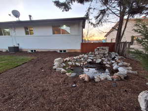 View of property exterior featuring brick siding and a cooling unit