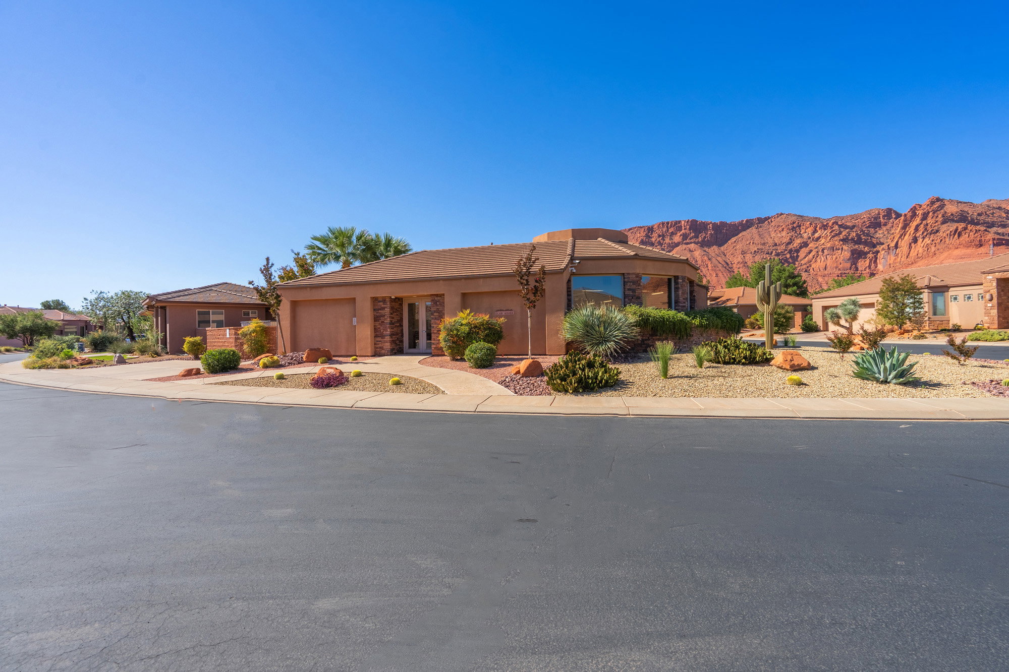 View of front of home featuring driveway, stucco siding, and a garage