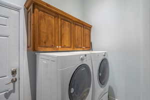 Laundry area with cabinet space and washing machine and dryer