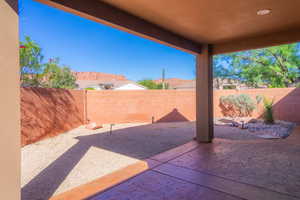 Fenced backyard with a patio area