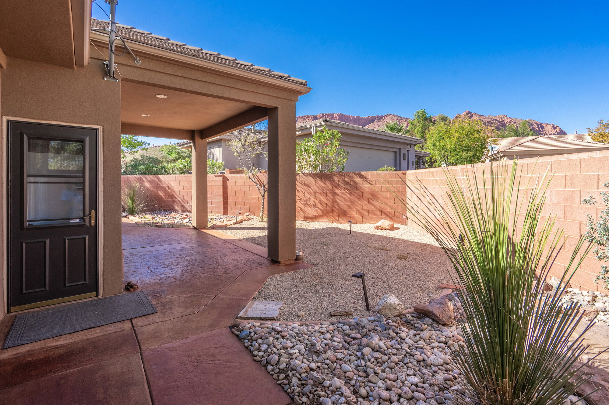 Fenced backyard with a patio area