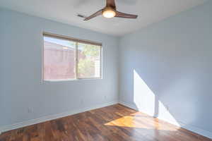 Spare room with hardwood / wood-style flooring and a ceiling fan