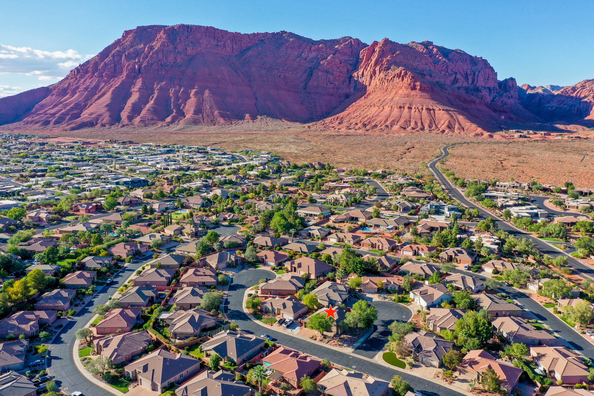 View of property location featuring mountains and nearby suburban area
