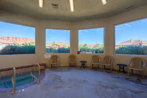 Sunroom / solarium featuring a jacuzzi, a mountain view, and carpet