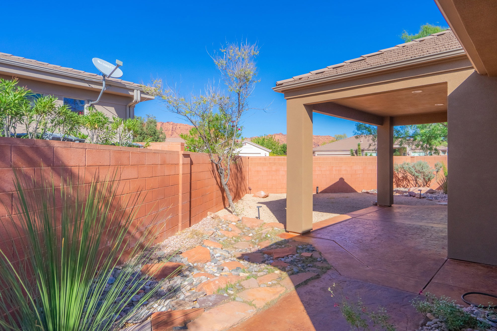 Fenced backyard with a patio area