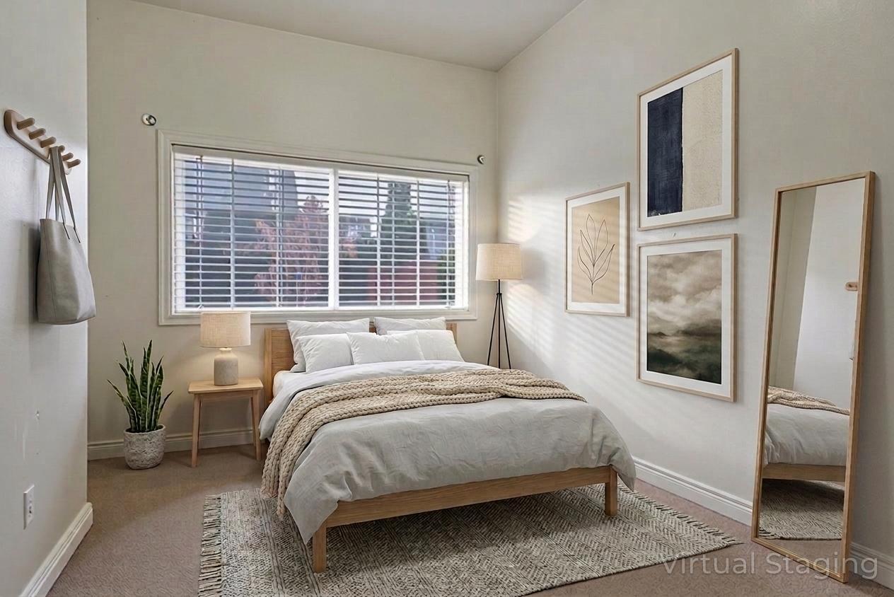 Bedroom with light carpet and baseboards