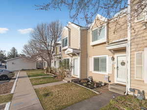View of side of home featuring a residential view and a yard