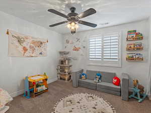 Recreation room with baseboards and carpet floors