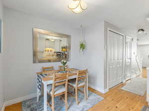 Dining area featuring light wood-type flooring and baseboards