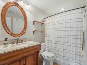 Full bathroom with vanity and a shower with shower curtain