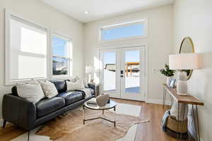 Living room with light wood-style flooring and french doors