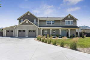 Craftsman house featuring board and batten siding, driveway, a garage, and a porch