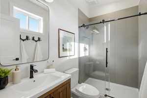 Full bathroom with vanity and a shower stall