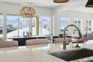 Kitchen with a mountain view, recessed lighting, healthy amount of natural light, open floor plan, and light stone counters