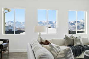 Living area featuring a mountain view, wood finished floors, and healthy amount of natural light